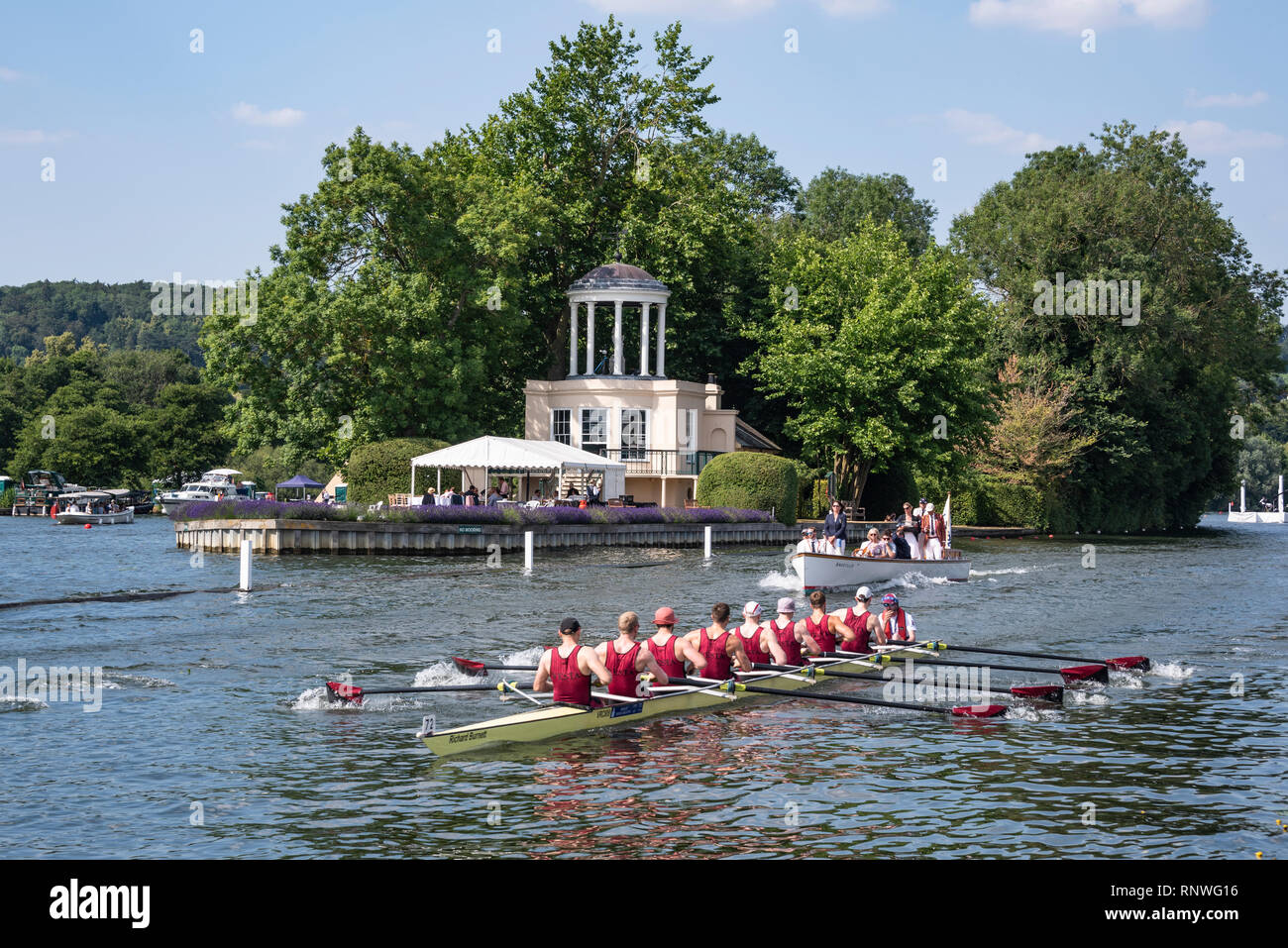 A rowing crew passes Temple Island, on the River Thames near Henley on