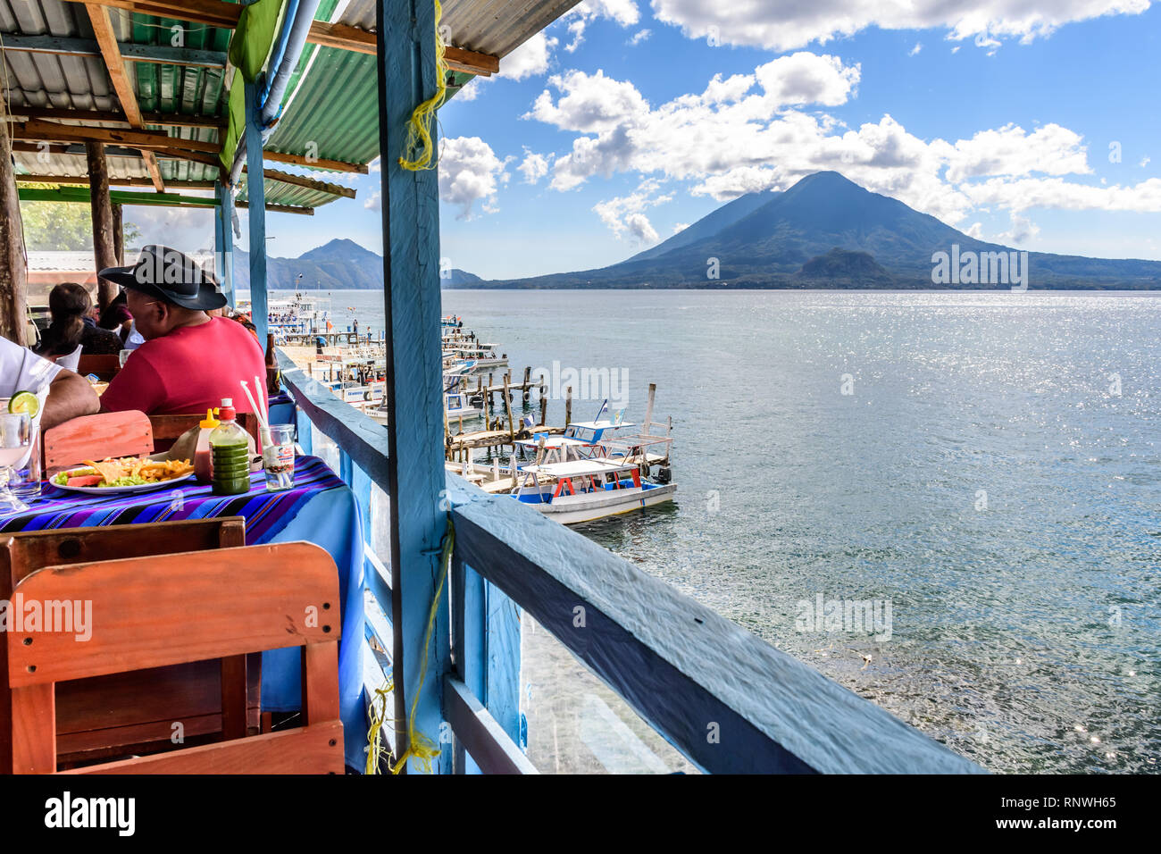 Panajachel, Lake Atitlan, Guatemala - December 25, 2018: Lakeside restaurant on Christmas Day in Panajachel with Atitlan & Toliman volcanoes behind. Stock Photo