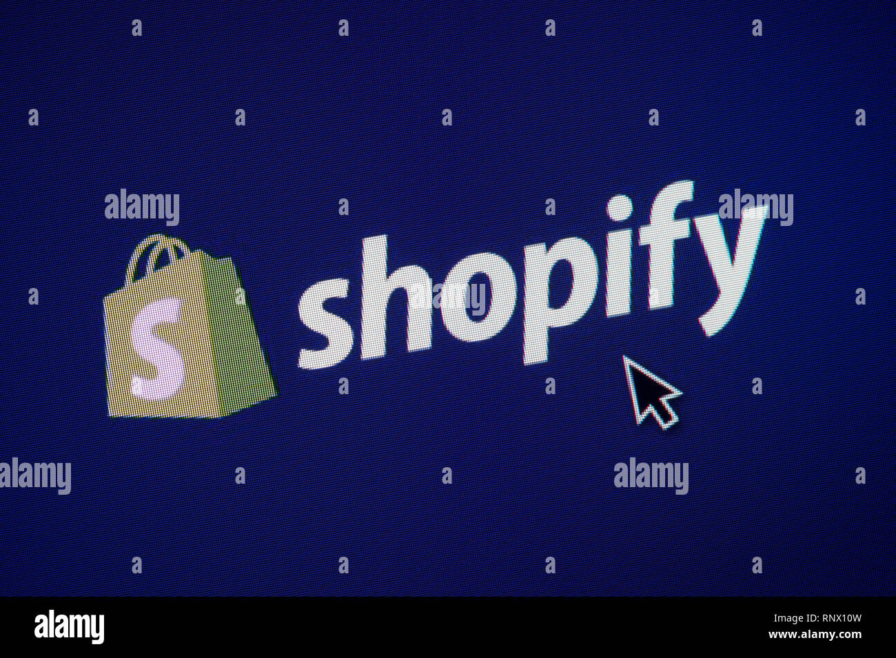 The logo of Shopify is seen on a computer screen along with a mouse ...