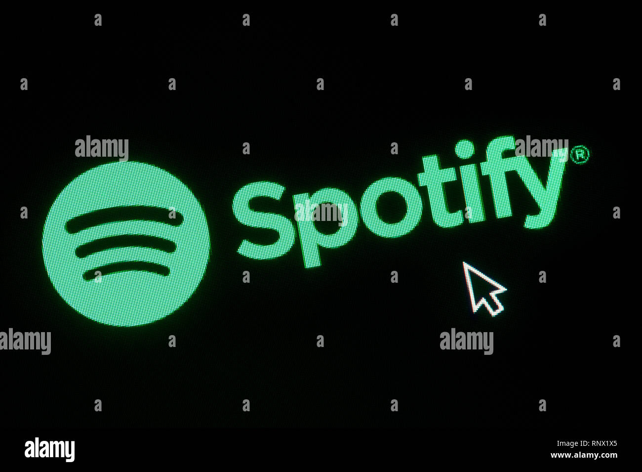 The logo of Spotify is seen on a computer screen along with a mouse cursor (Editorial use only) Stock Photo