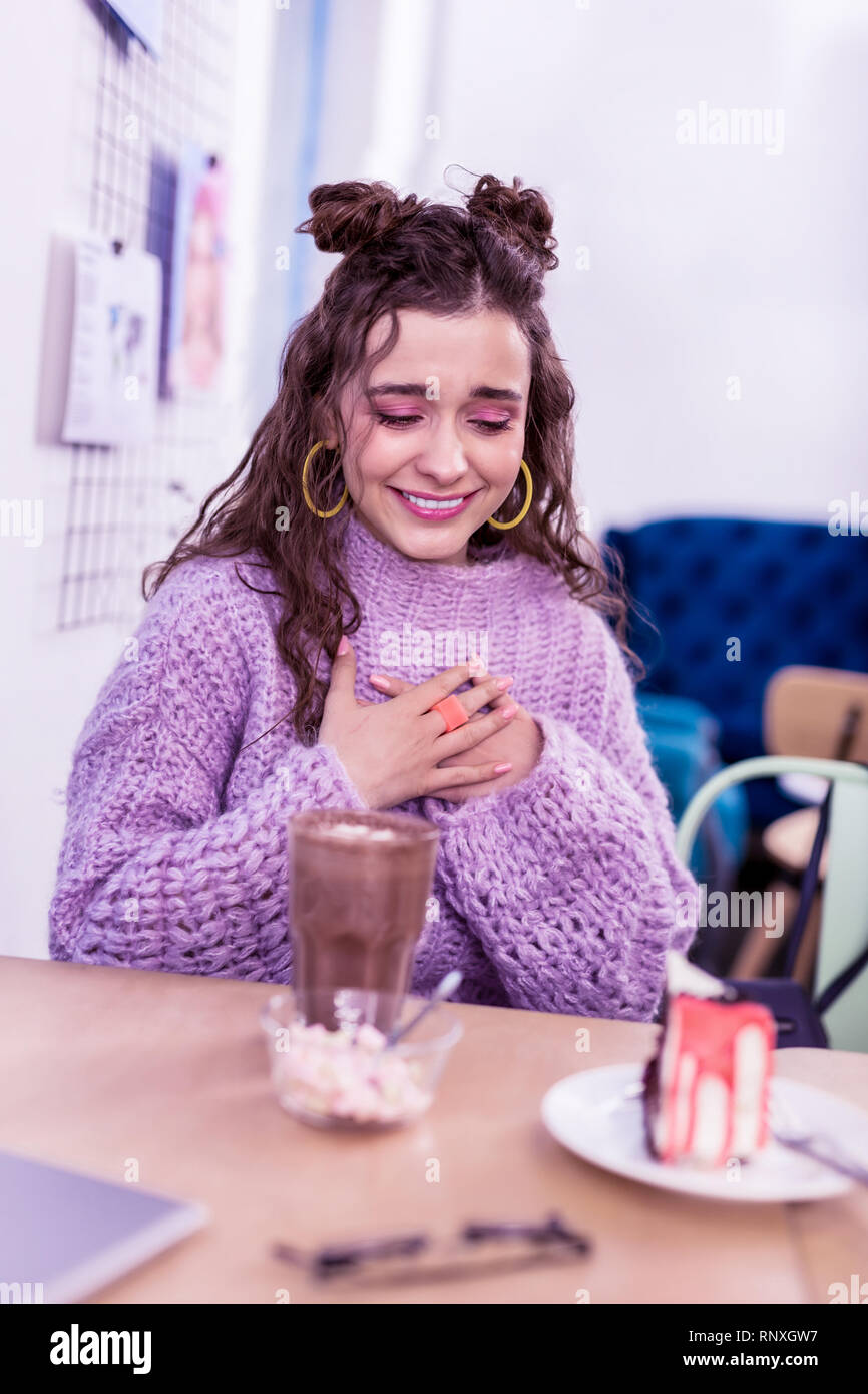 Pretty young lady being extremely sentimental and happy with dessert Stock Photo