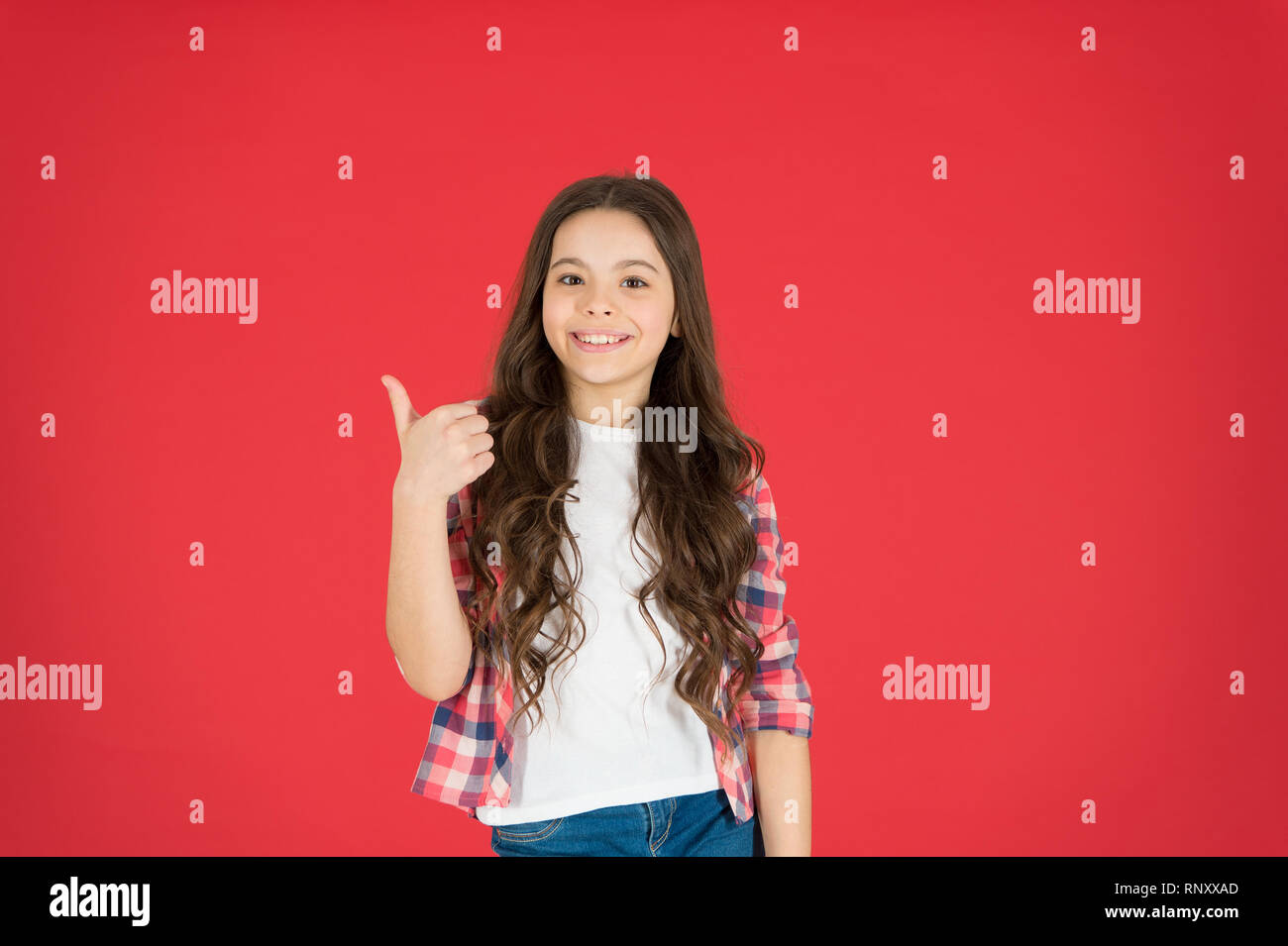 Recommend something. This is awesome. Girl cute child show thumbs up gesture. Teens totally love. Kid show thumbs up. Girl happy totally in love fond of or highly recommend. Thumbs up approvement. Stock Photo