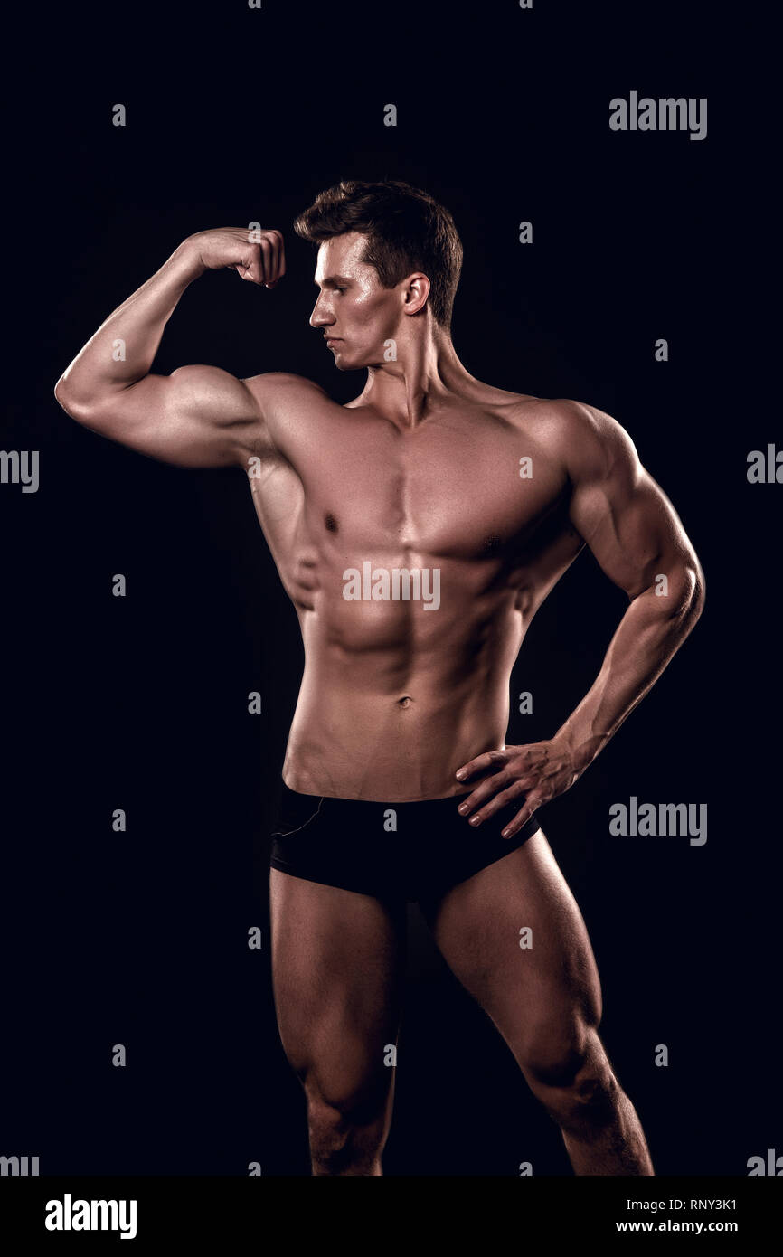 Bodybuilder flex arm with biceps, triceps. Man show muscular body, muscles.  Sportsman with bare torso, six pack, ab on black background. Sport,  bodybuilding, fitness. Healthy lifestyle concept Stock Photo - Alamy