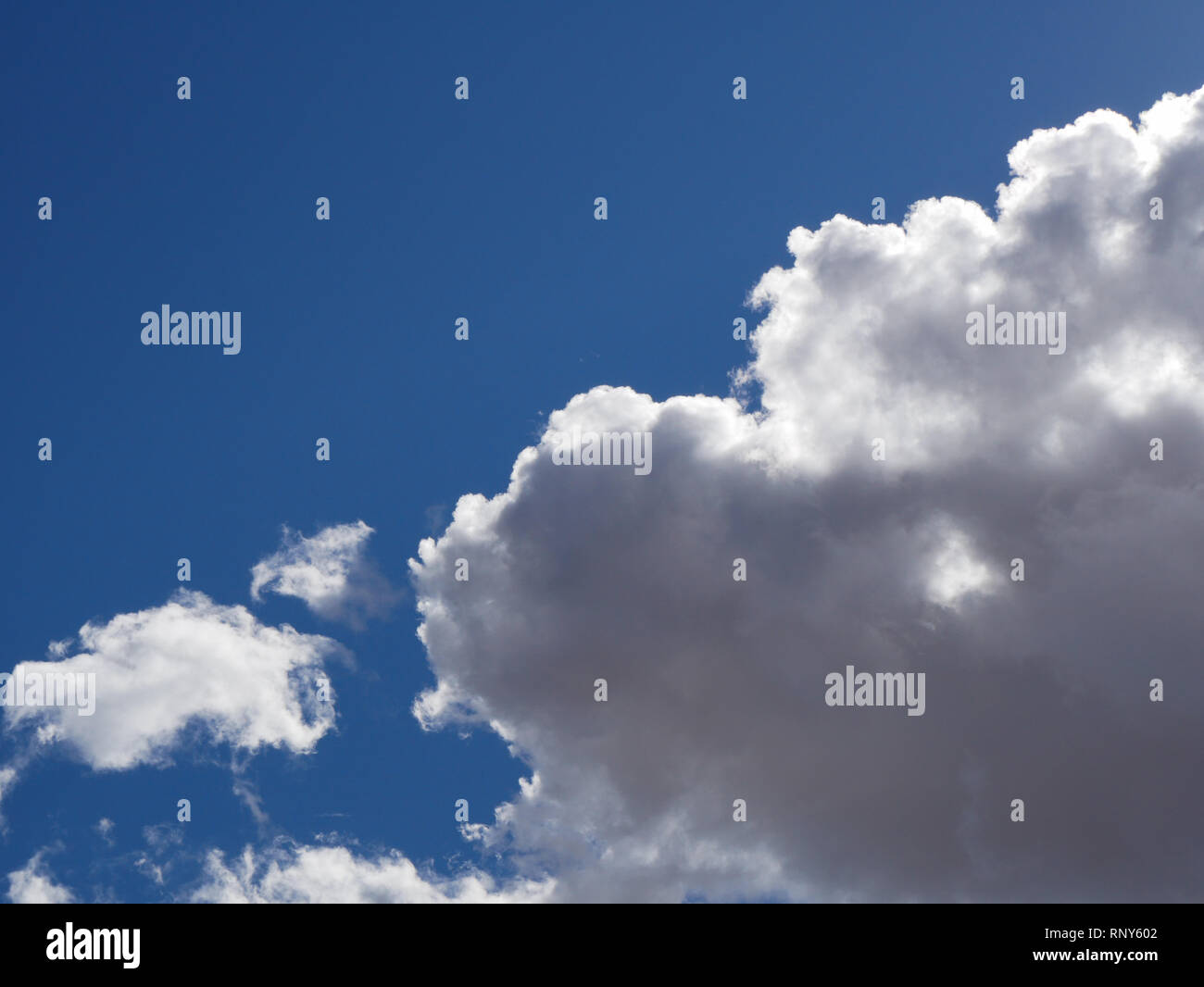 Vibrant blue sky with fluffy clouds Stock Photo - Alamy
