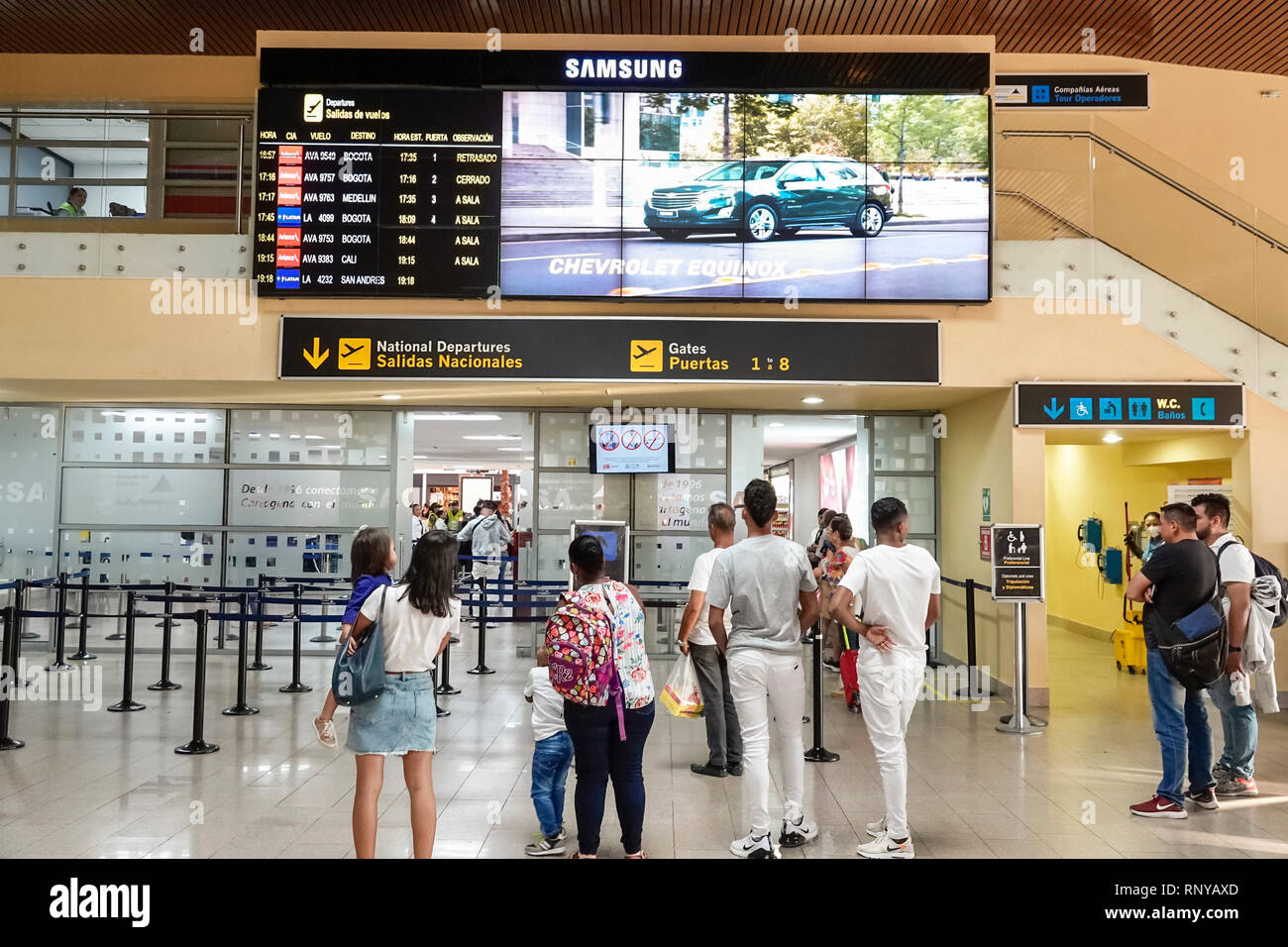 Cartagena Colombia,Aeropuerto Internacional Rafael Nunez Airport,inside interior,terminal,departure gates,flight information board,Hispanic man men ma Stock Photo