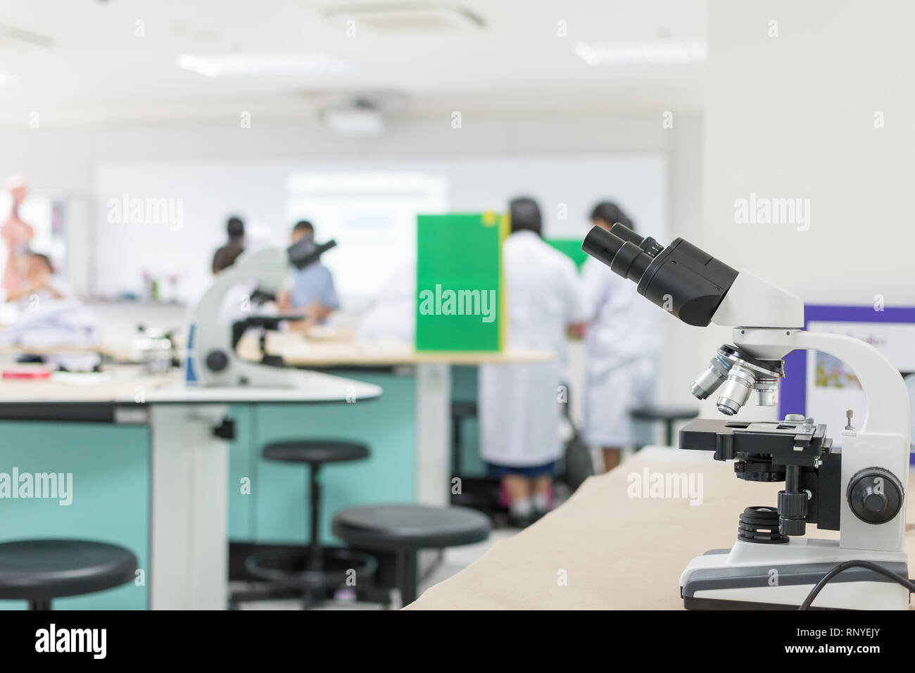 Biology or chemistry science class study with microscope and blur