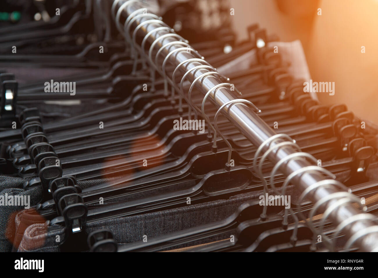 Selective focus clothes hangers in the store with blur. Close up. Stock Photo