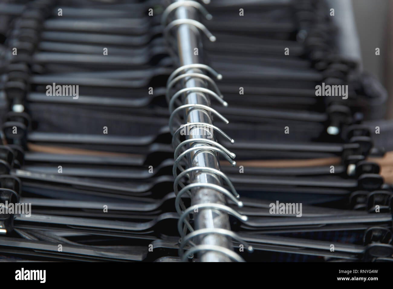 Selective focus clothes hangers in the store with blur. Close up. Stock Photo