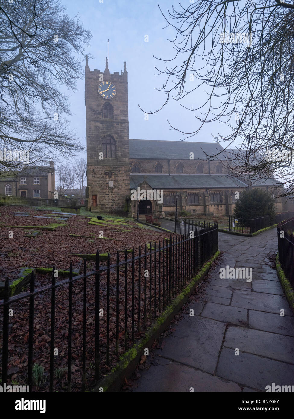 Haworth Church, West Yorkshire, associated with the Bronte family shown in early morning mist in winter. Stock Photo