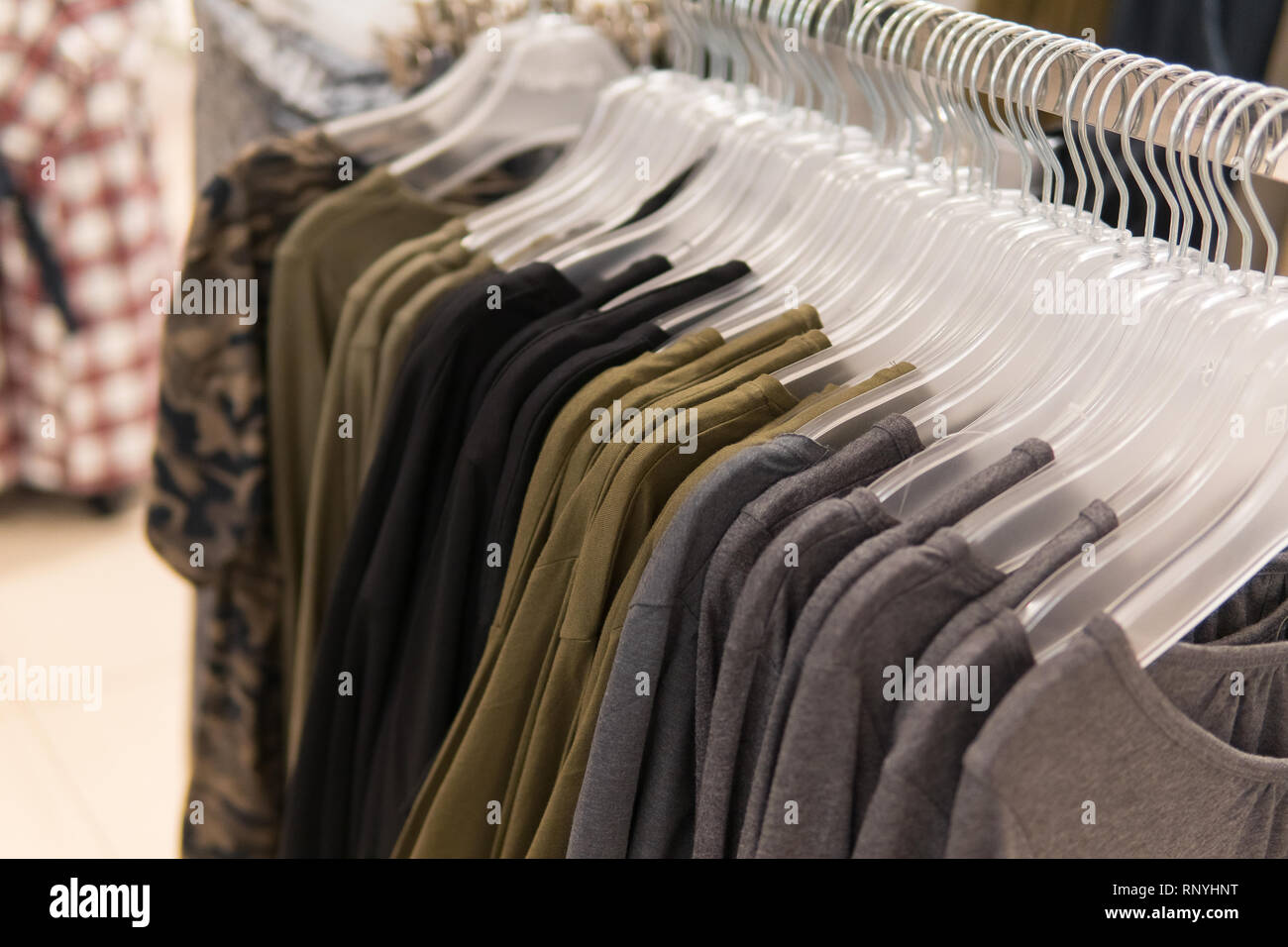 Men Clothes Row Of T Shirt Collection On The Hanger In The Shop