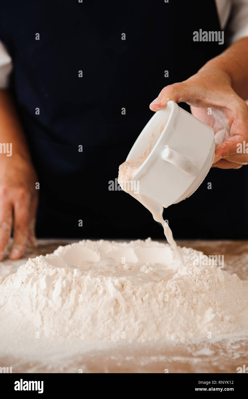 Making dough by female hands at bakery Stock Photo - Alamy