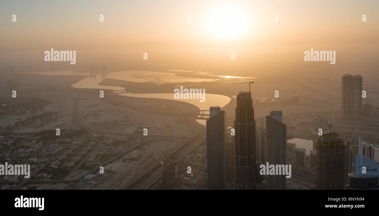 DUBAI, UAE - February 17, 2018: Looking down from the Burj Khalifa and distant desert haze at sunrise, Dubai, UAE Stock Photo