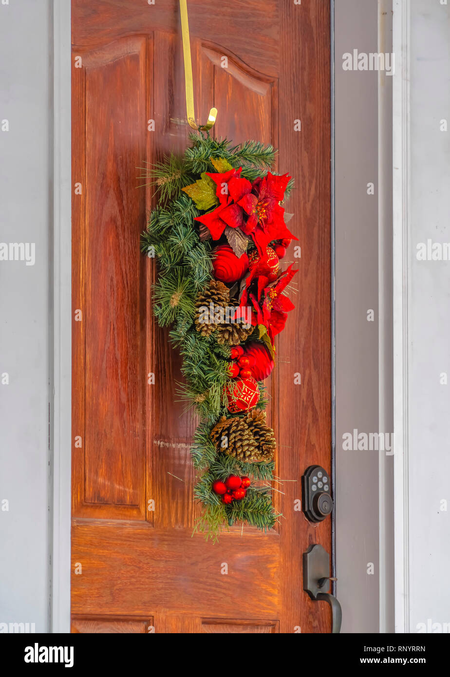 Leafy Door Decoration With Flowers And Pinecones Stock Photo