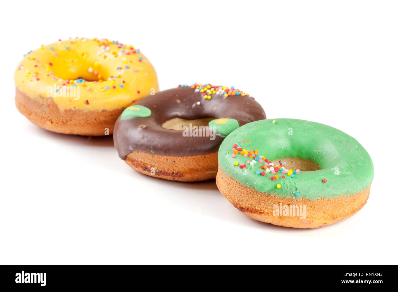 three glazed donut isolated on white background Stock Photo - Alamy
