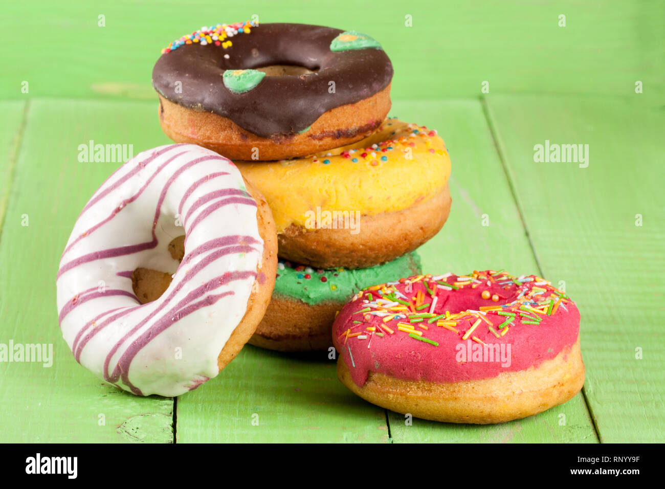 pile of glazed donuts isolated on white background Stock Photo - Alamy
