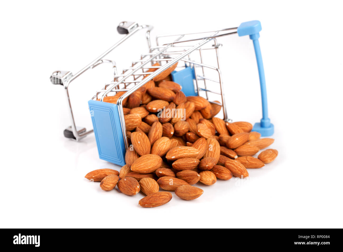 Shopping cart with raw almond isolated on white background Stock Photo