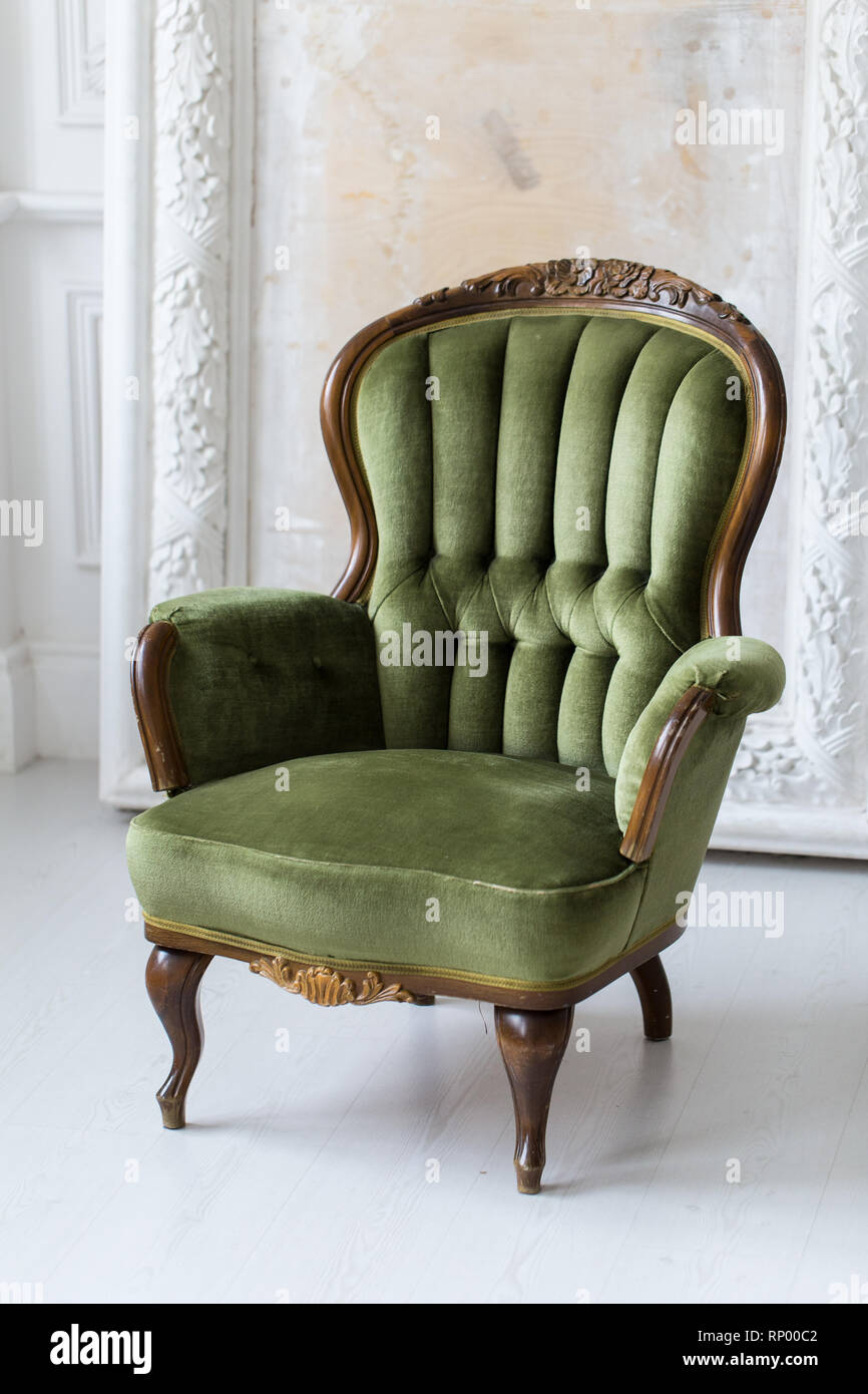 Vintage armchair in green color. Rococo style. Selective focus. Stock Photo