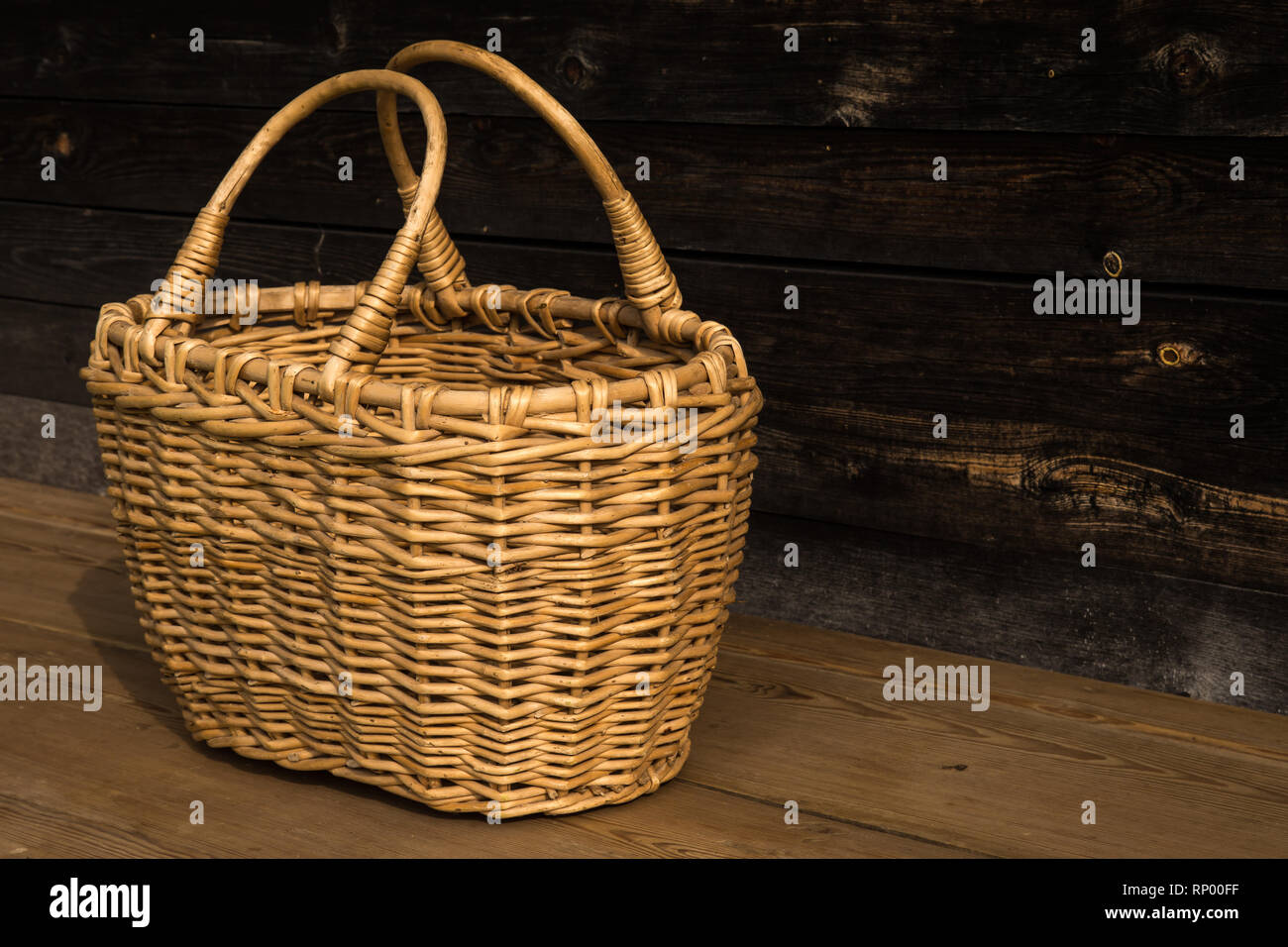 Ancient wicker basket on a wooden background. Selective focus. Free space  for text Stock Photo - Alamy