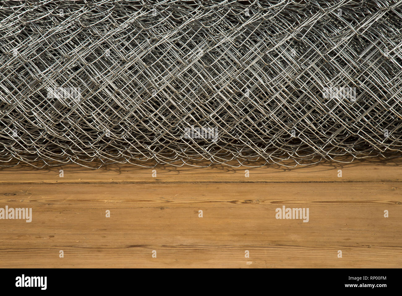 Rabitz grid in a roll on a wooden background Stock Photo