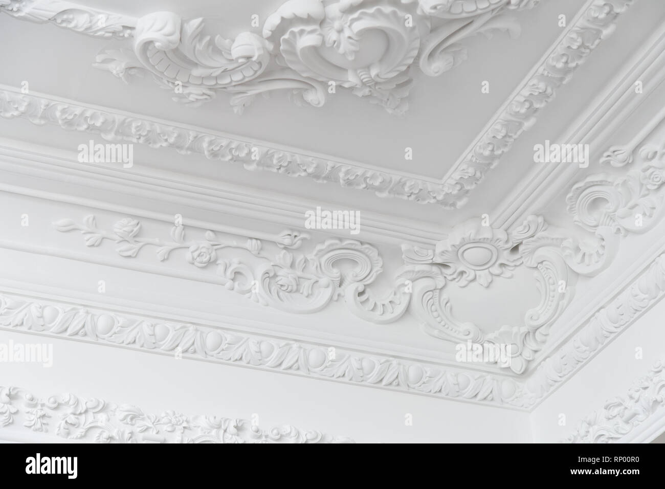 Beautiful ornate white decorative plaster moldings in studio Stock Photo
