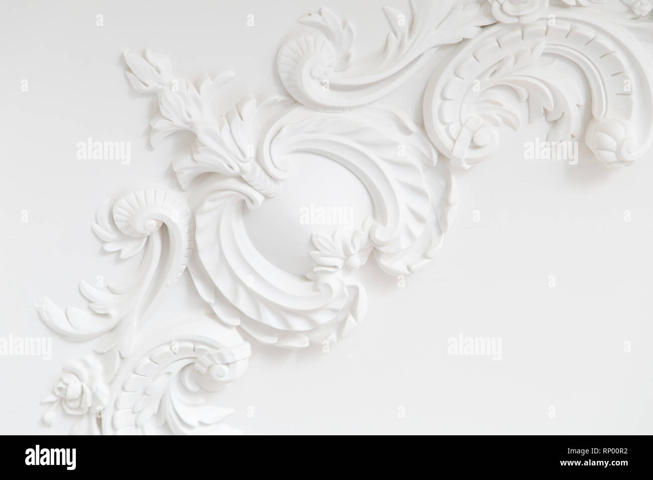 Beautiful ornate white decorative plaster moldings in studio Stock Photo