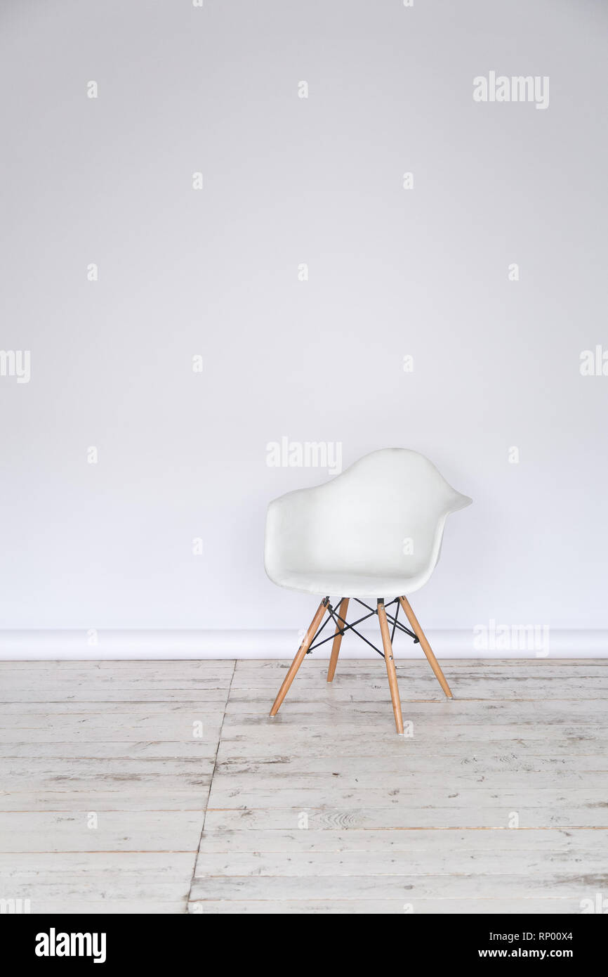 The working space of the photo studio with a white paper background and chair. Stock Photo