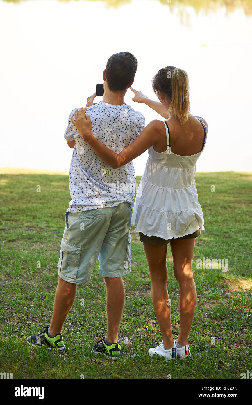 Young couple standing in park Stock Photo