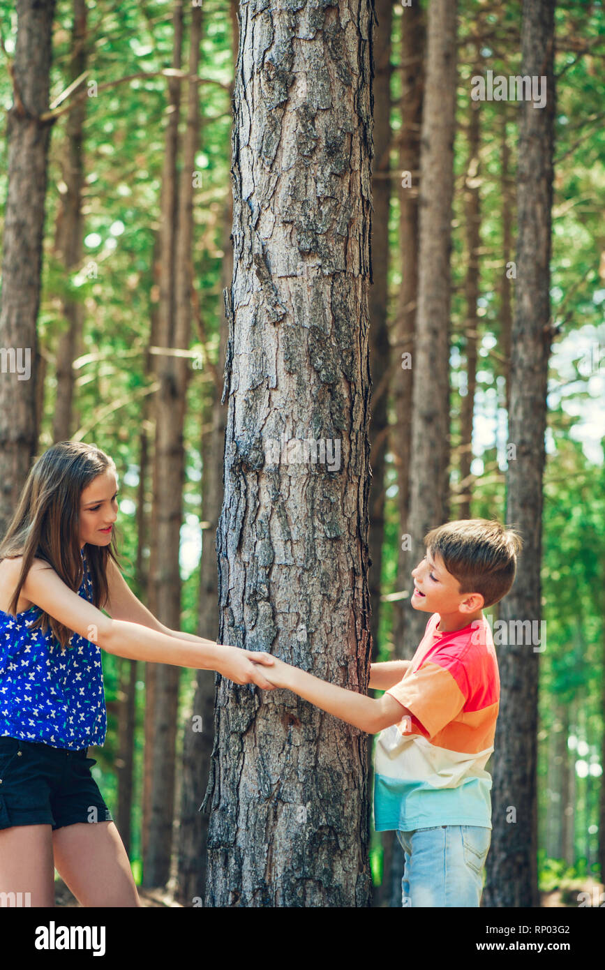 Brother and sister playing in forest Stock Photo - Alamy