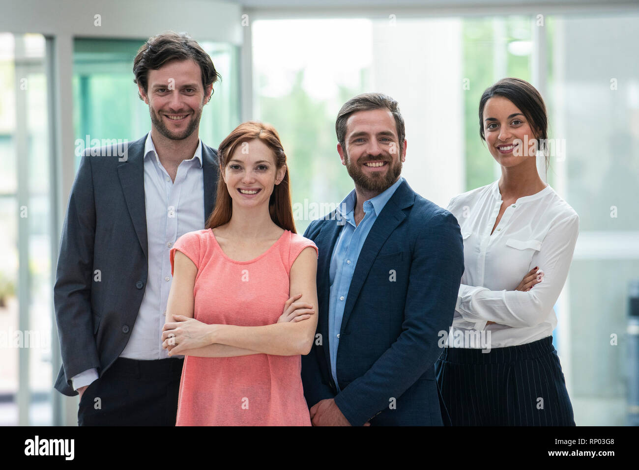 Smiling business people standing in hotel lobby Stock Photo - Alamy