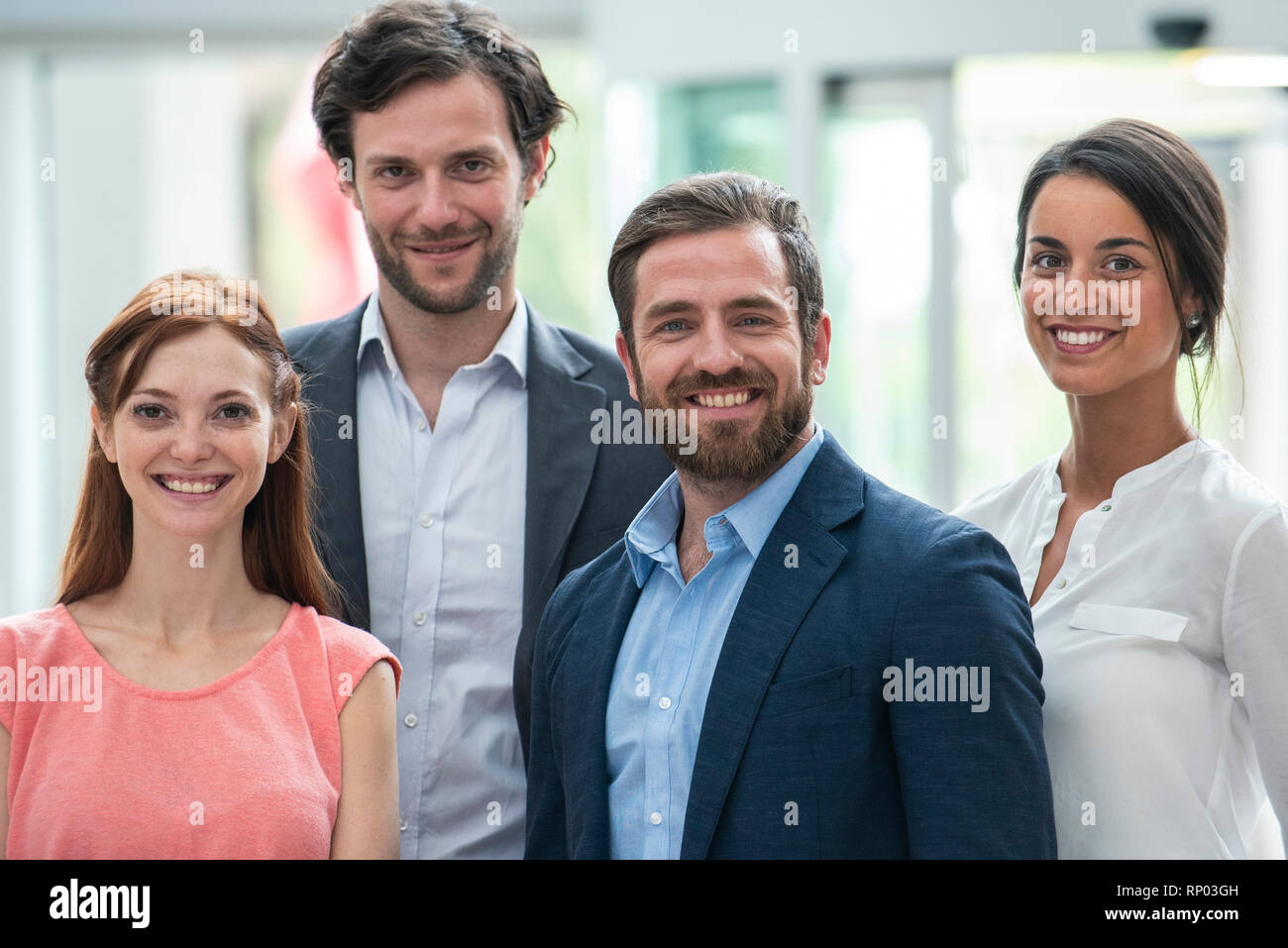 Smiling business people standing in hotel lobby Stock Photo - Alamy