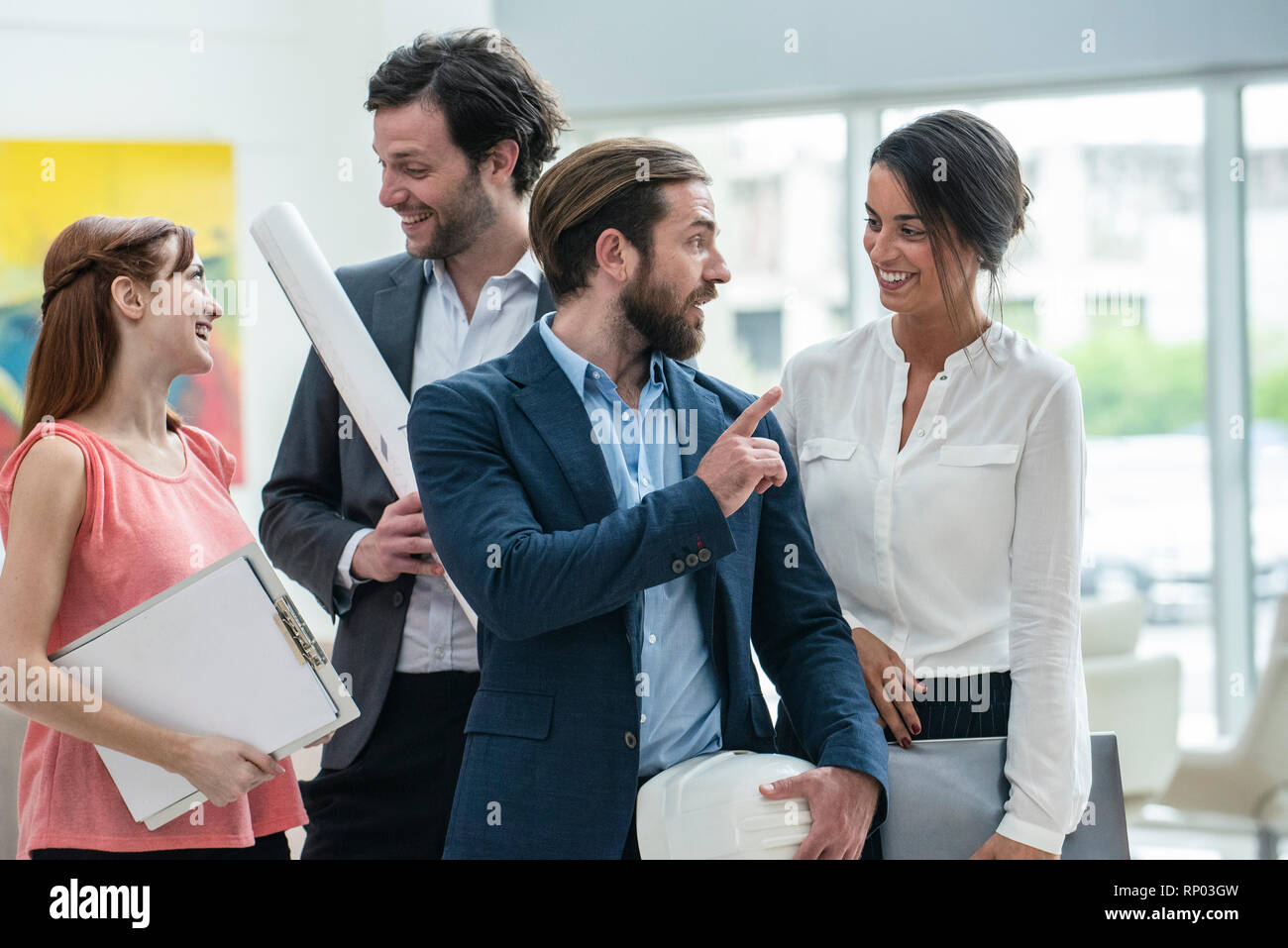 Smiling architects standing in hotel lobby Stock Photo - Alamy