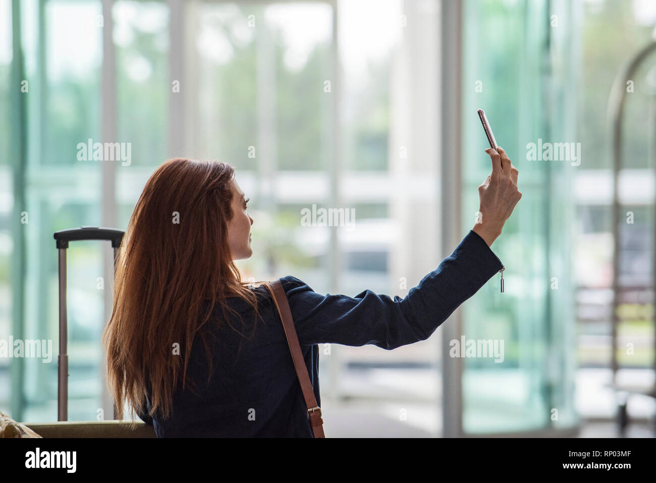 Businesswoman taking selfie with smart phone Stock Photo