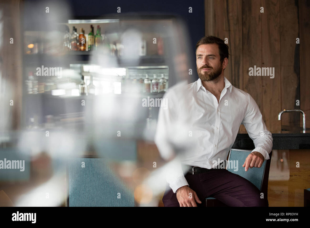 Mid adult man sitting in bar Stock Photo