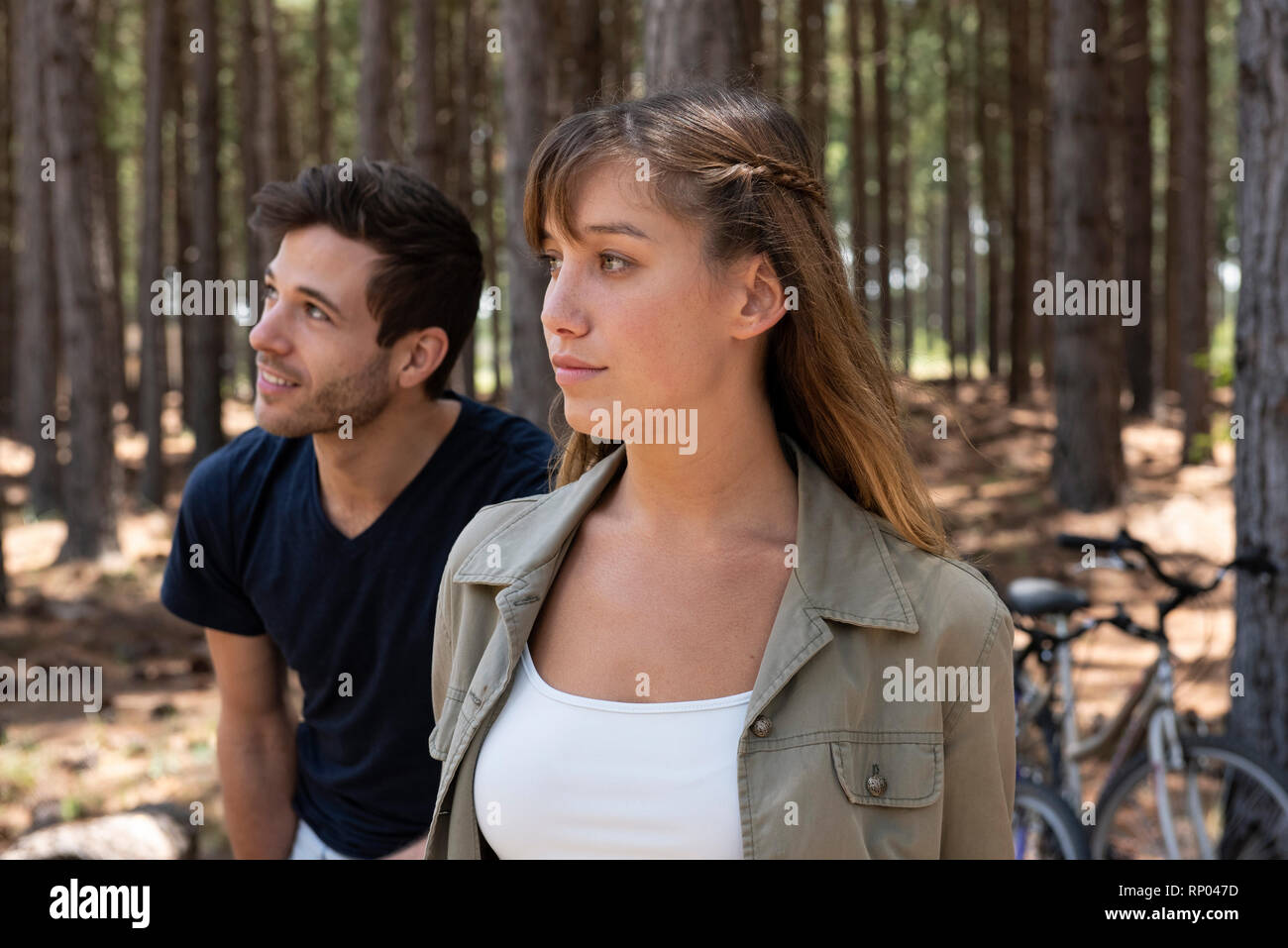 Young couple standing in forest Stock Photo