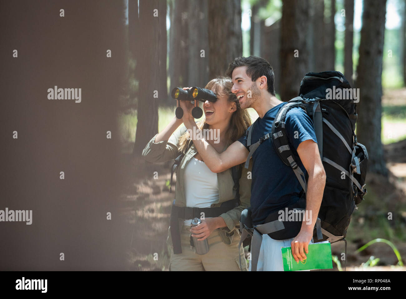 Young couple hiking in forest Stock Photo