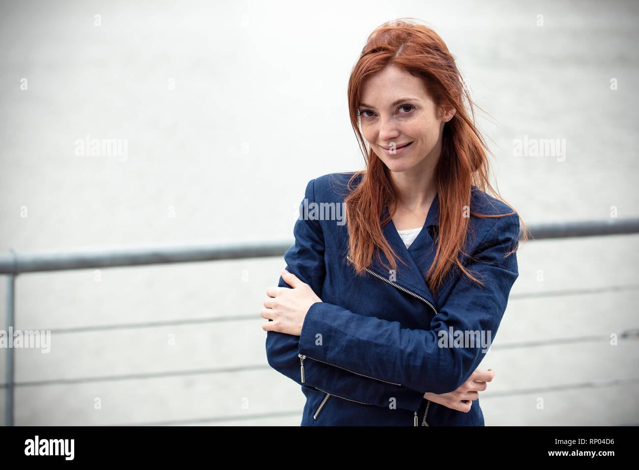 Woman standing smiling hi-res stock photography and images - Alamy