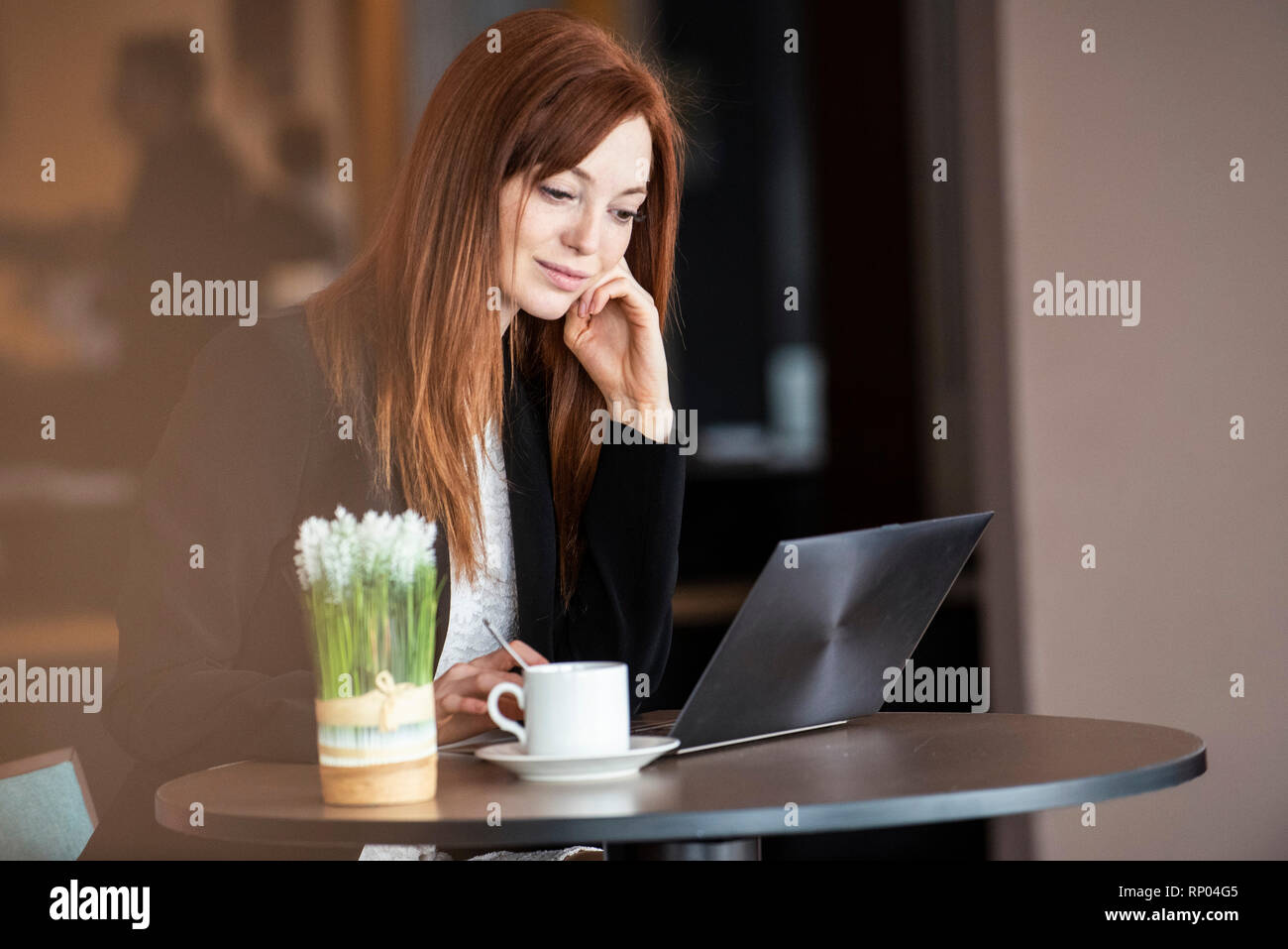 Businesswoman using laptop in hotel Stock Photo