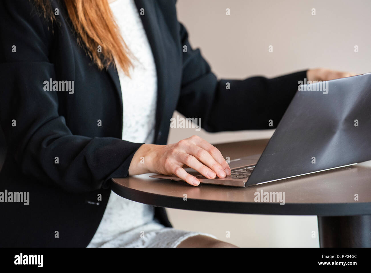 Businesswoman using laptop in hotel Stock Photo