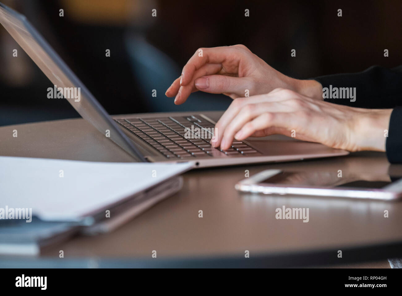 Businesswoman using laptop in hotel Stock Photo