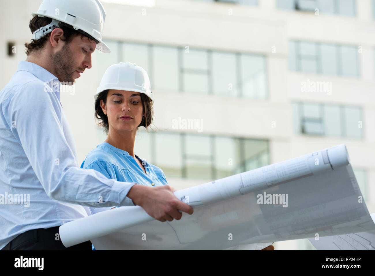 Architects reviewing blueprint Stock Photo