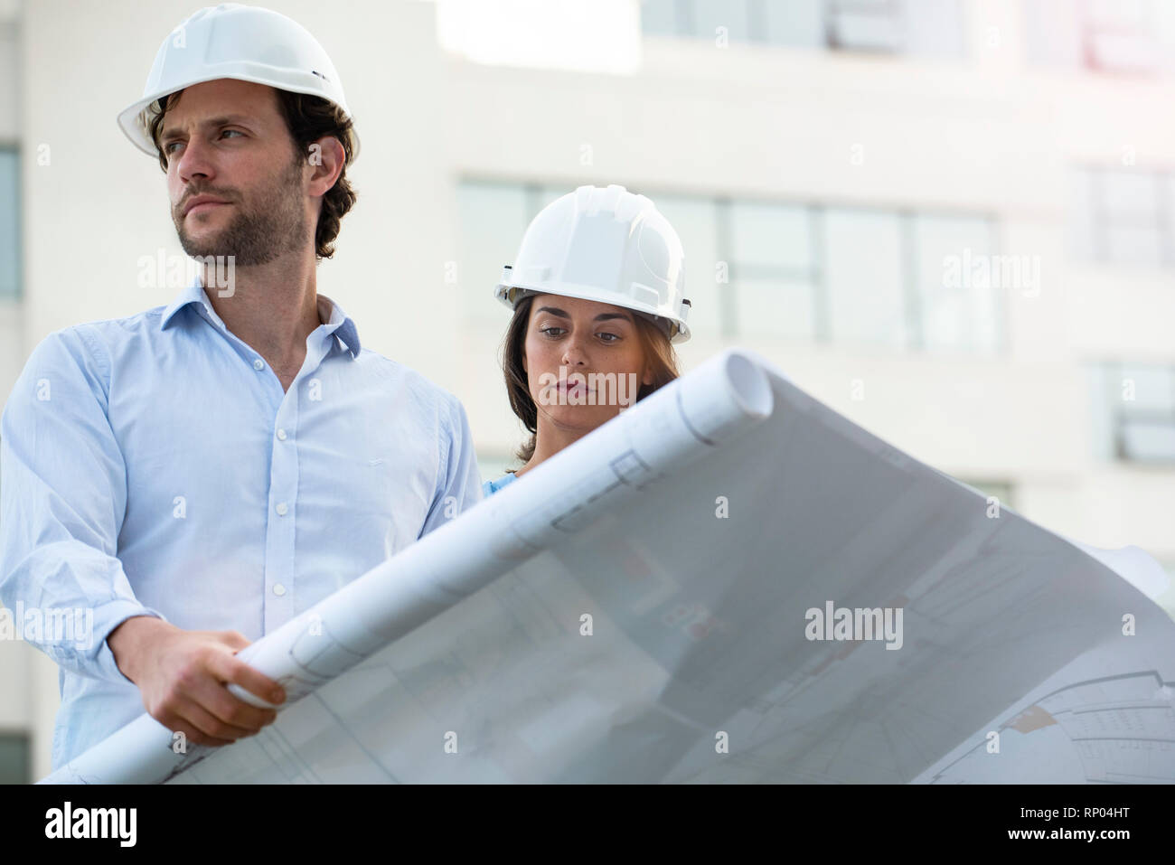 Architects reviewing blueprint Stock Photo