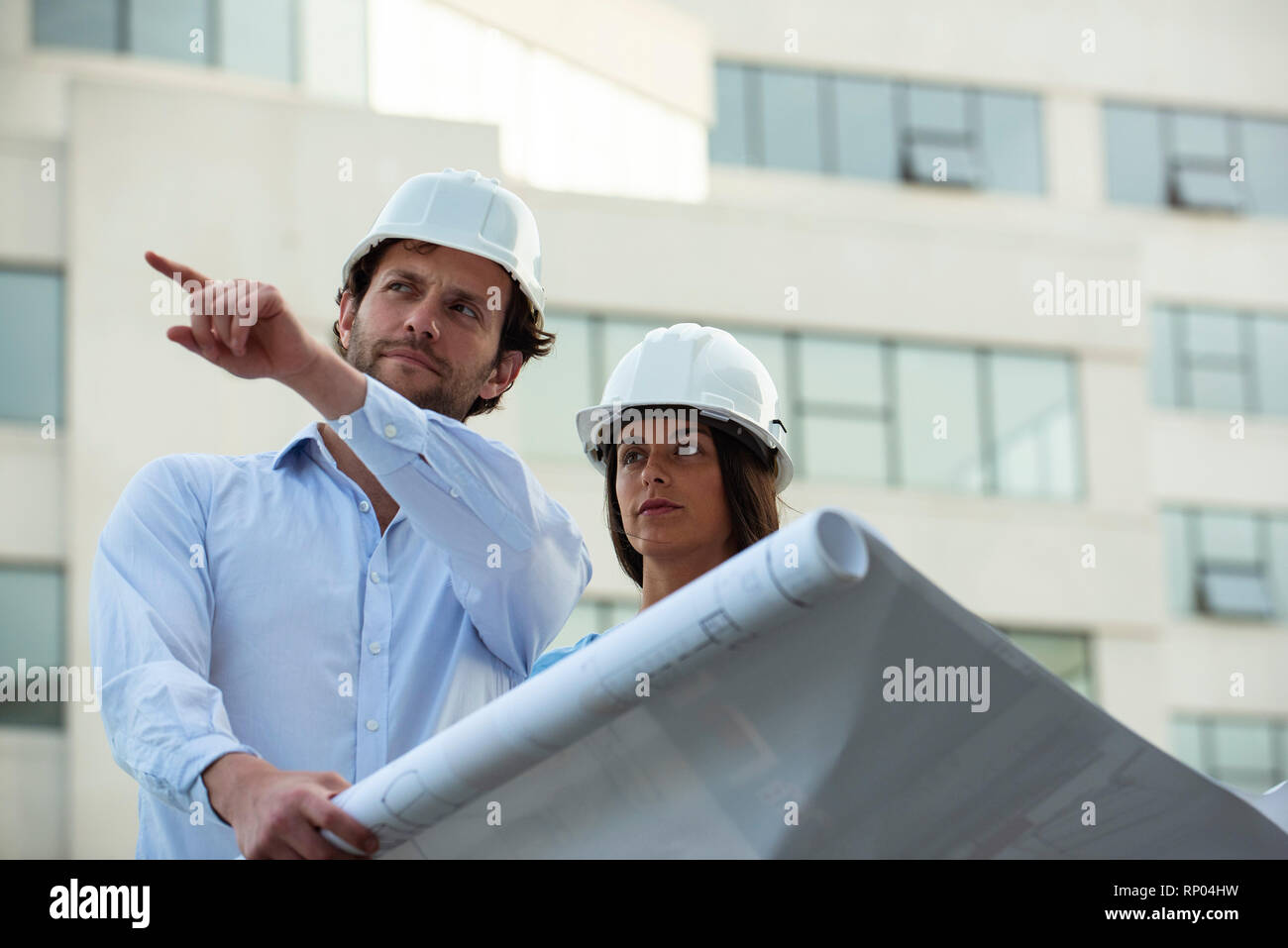 Architects reviewing blueprint Stock Photo