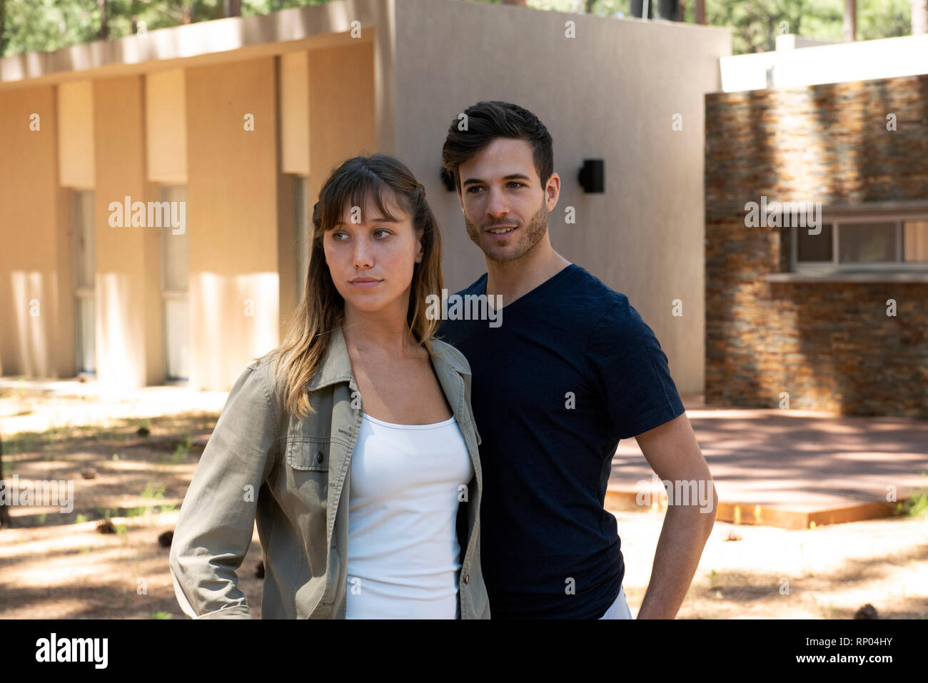 Thoughtful young couple standing outdoors Stock Photo