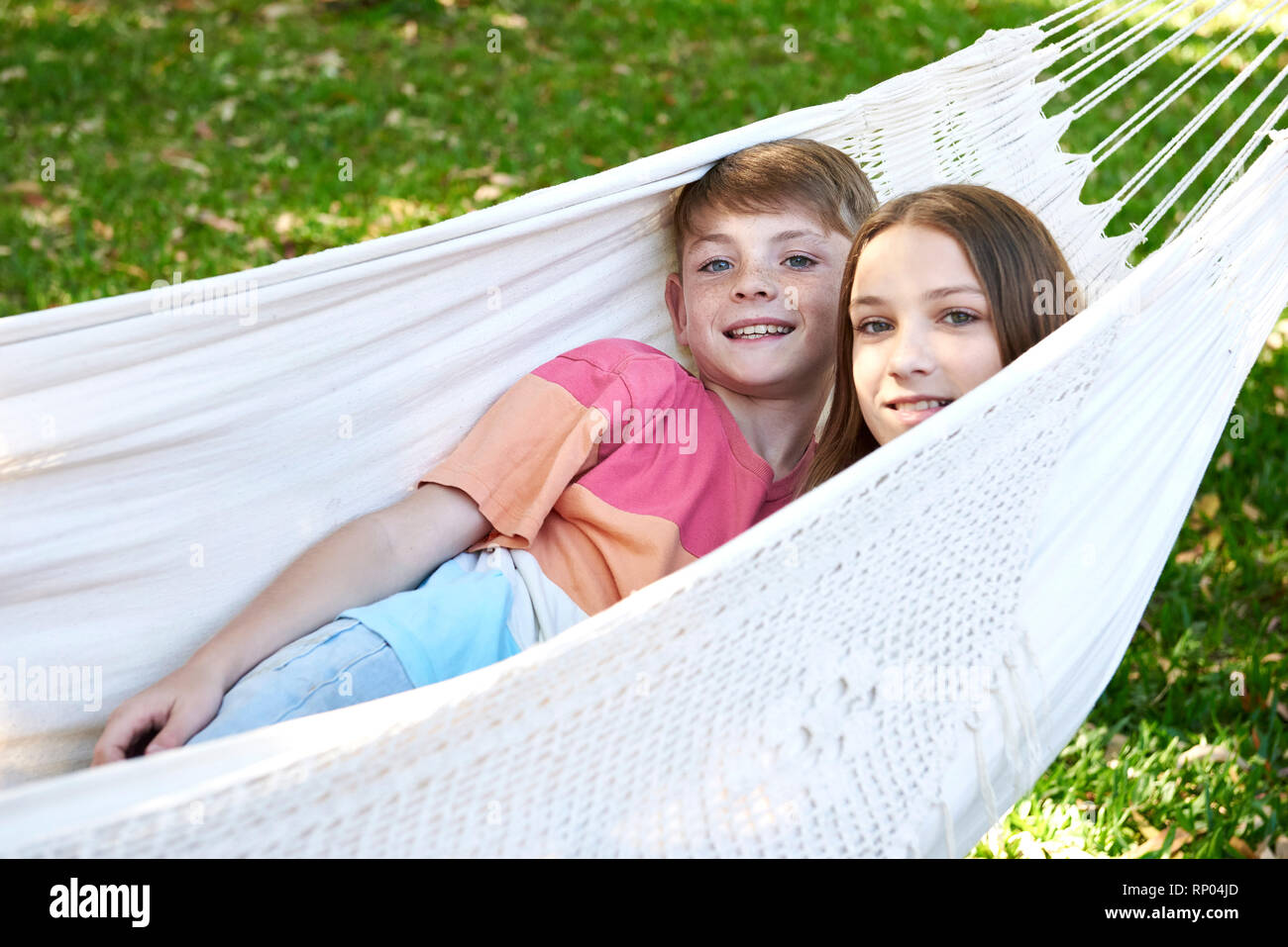 Brother and sister relaxing in a hammock Stock Photo - Alamy