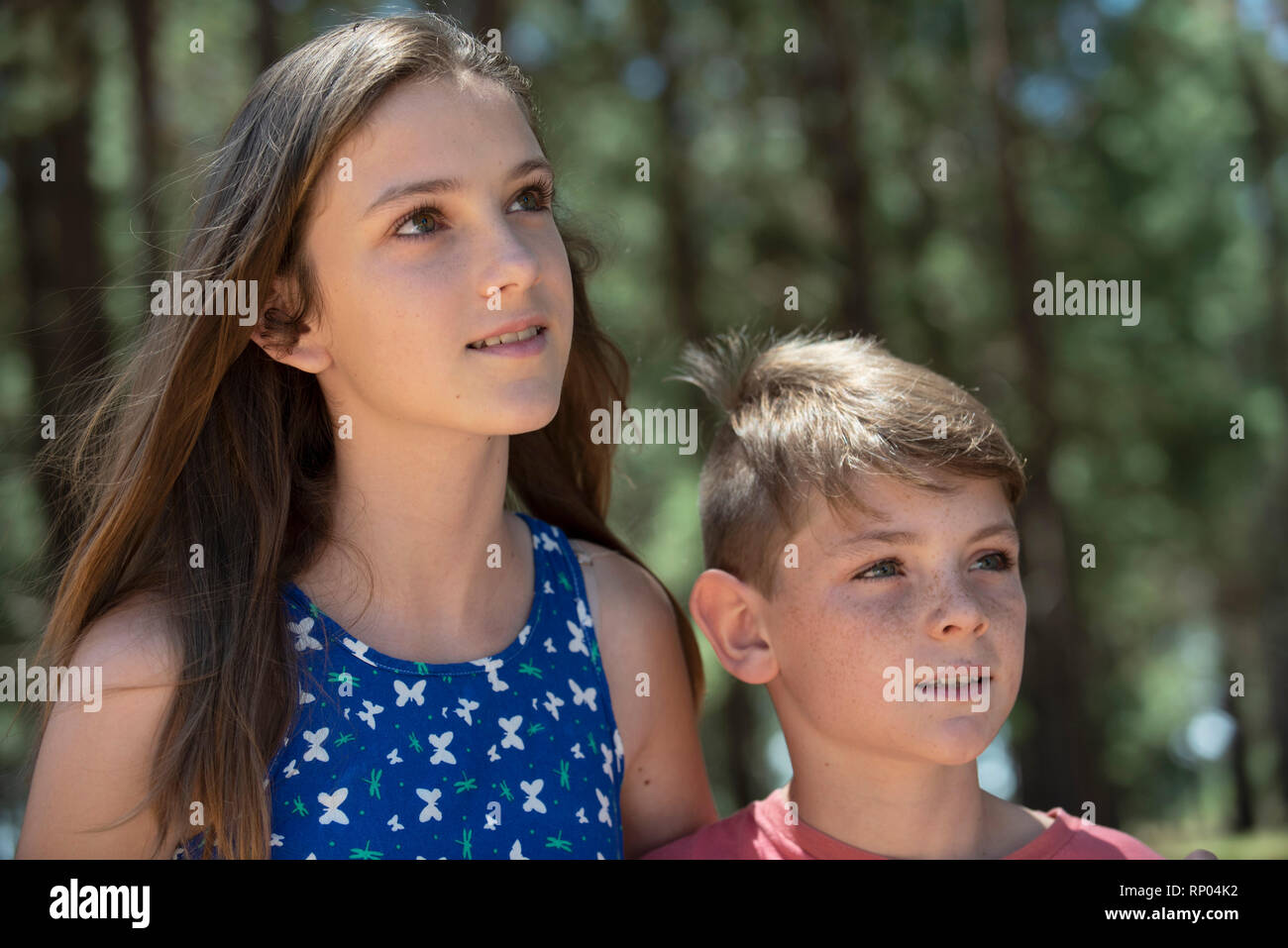 Thoughtful brother and sister standing outdoors Stock Photo