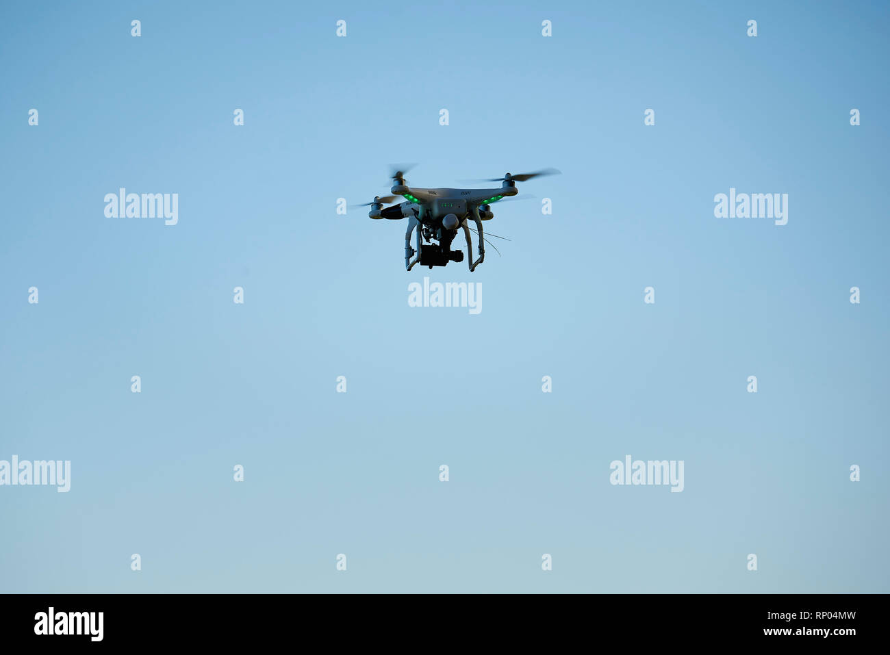 Drone flying against blue sky Stock Photo