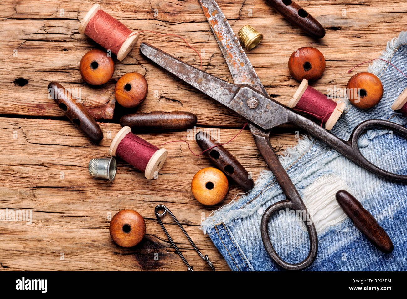 Spools of thread and basic sewing tools on wooden table.Sewing kit Stock Photo