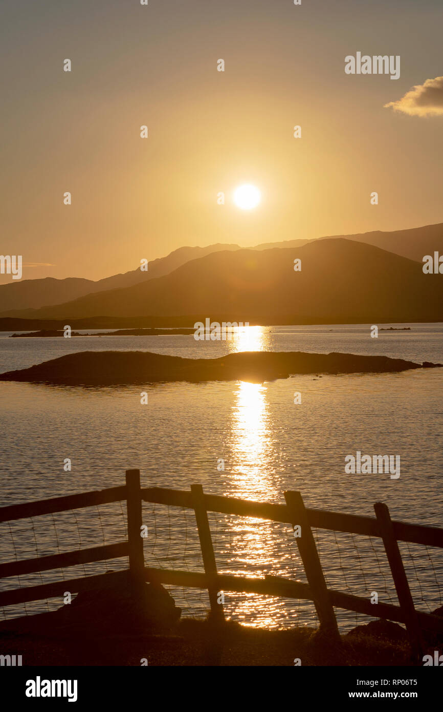 Sunrise over Loch Bee/ Loch Bi, the popular fishing inland loch with views behind of the hills of South Uist, Outer Hebrides, Scotland, UK Stock Photo