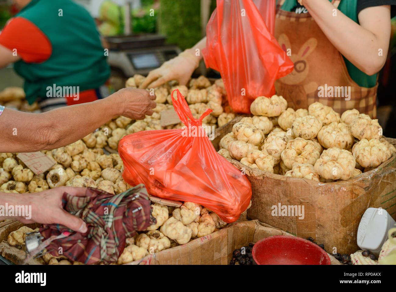 Vendor sells edible lily bulbs Stock Photo Alamy