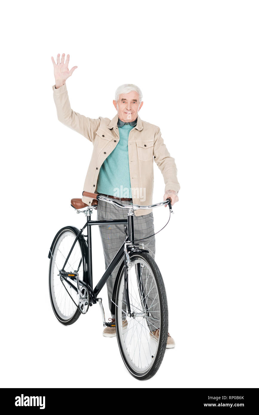 cheerful retired man holding bike and waving hand isolated on white Stock Photo Alamy